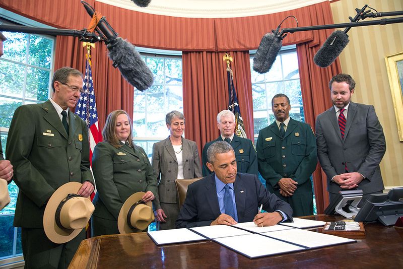 President Obama signs order viewed by members of National Park Service