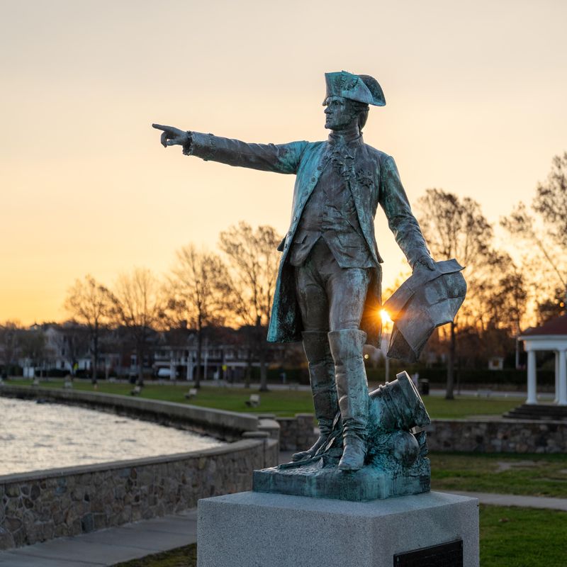 Bronze statue of Rochambeau pointing near the Newport waterfront.